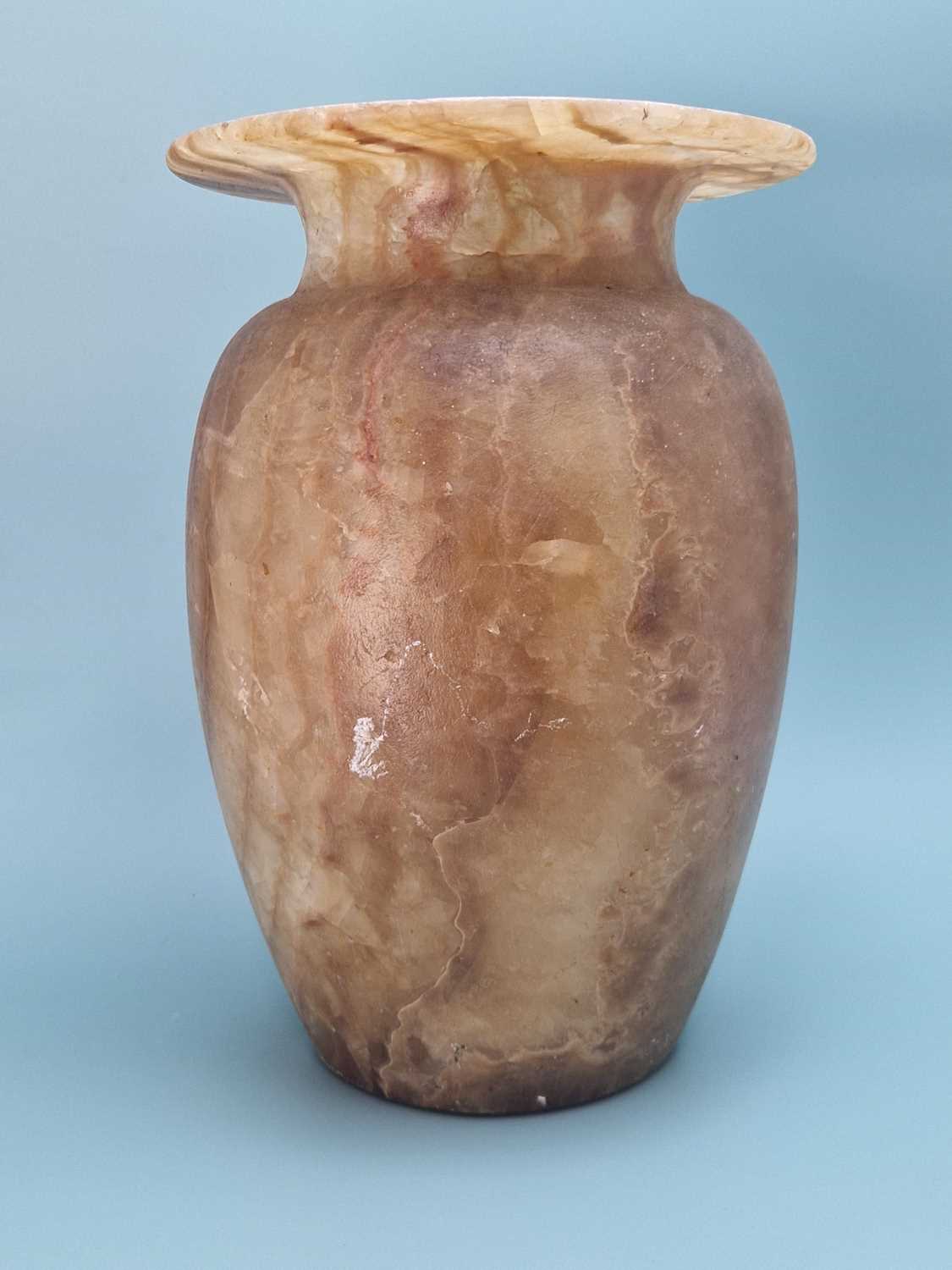 Lot 259 - A banded brown alabaster vase, the ovoid body...