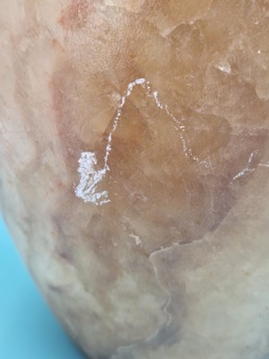 Lot 259 - A banded brown alabaster vase, the ovoid body...