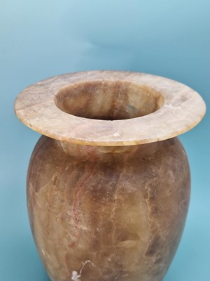 Lot 259 - A banded brown alabaster vase, the ovoid body...