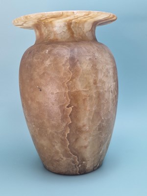 Lot 259 - A banded brown alabaster vase, the ovoid body...