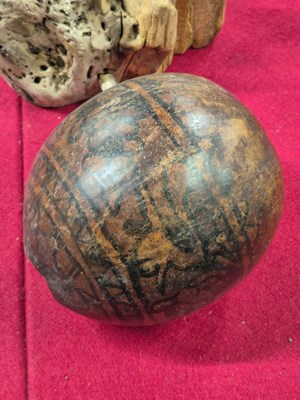 Lot 263 - A Guatemalan tribal gourd painted in black...