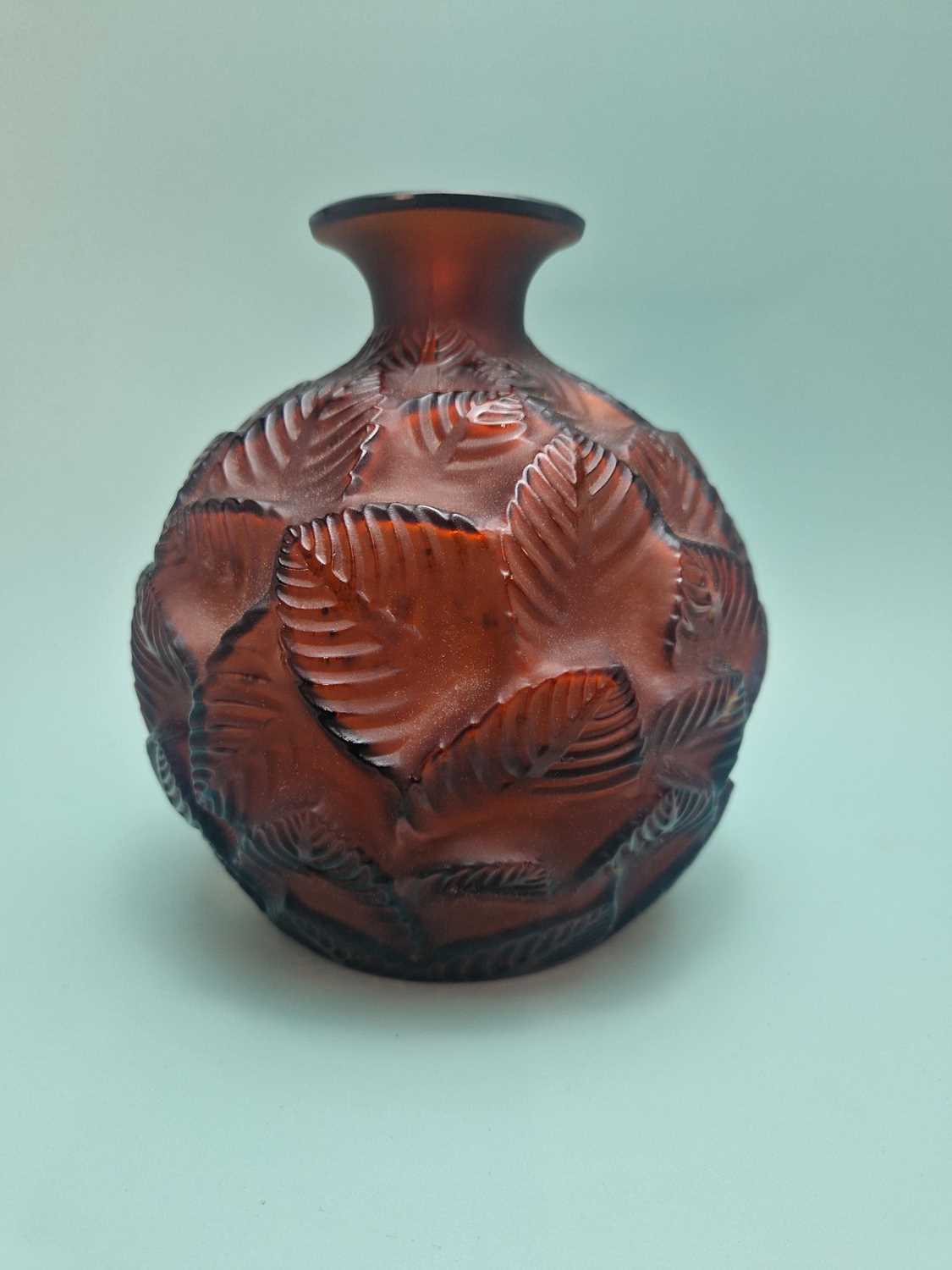 Lot 299 - A Lalique deep amber Feuilles Votive pattern...