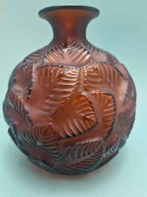 Lot 299 - A Lalique deep amber Feuilles Votive pattern...
