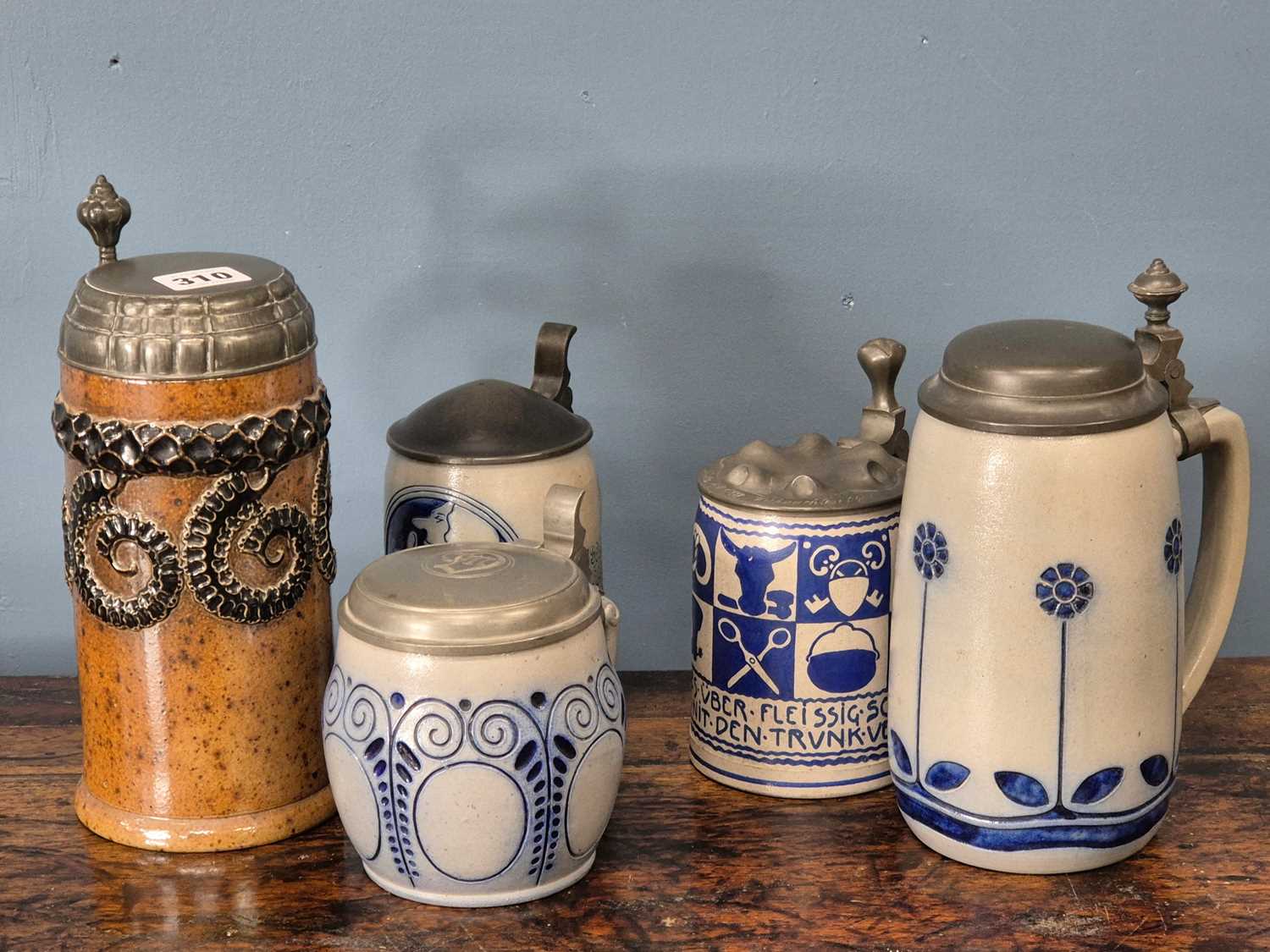 Lot 310 - Five various pewter lidded steins of which...