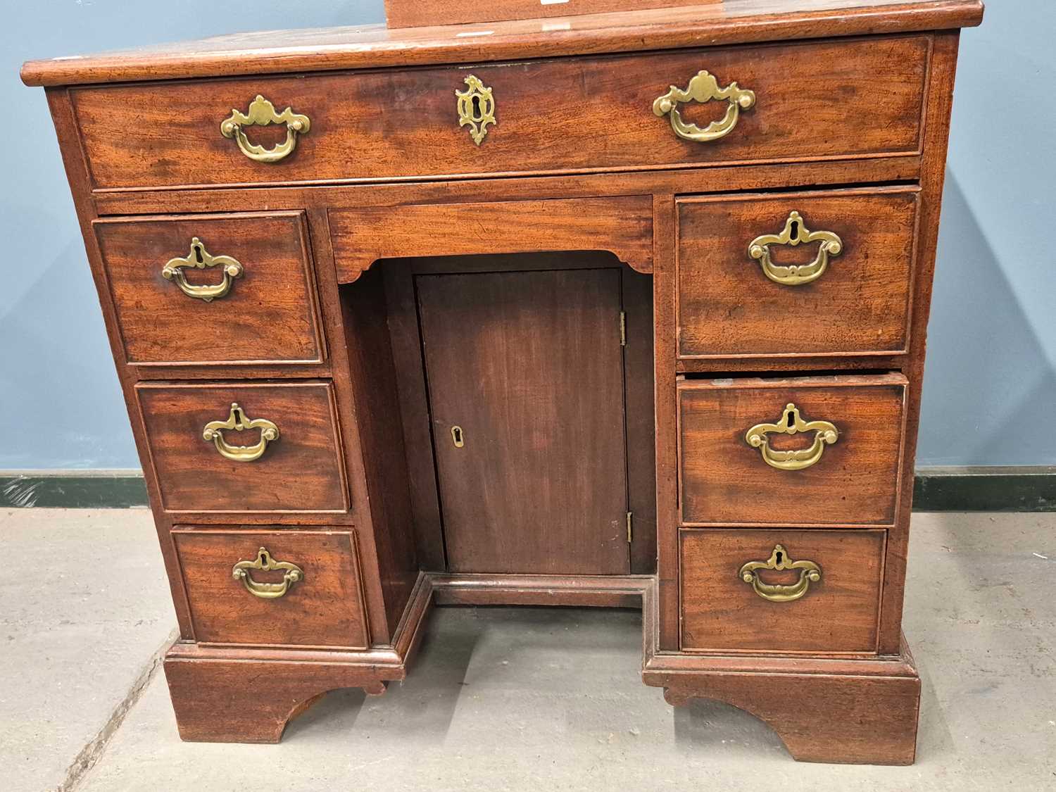 Lot 354 - A George III mahogany kneehole desk with banks...