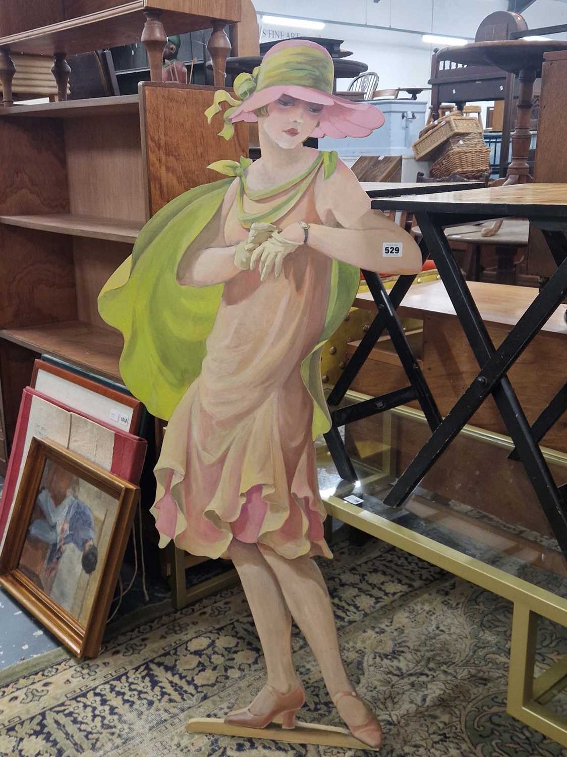Lot 529 - A painted dummy board of a 1920's lady looking...