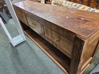 Lot 473 - A pine shop counter with three drawers over an...