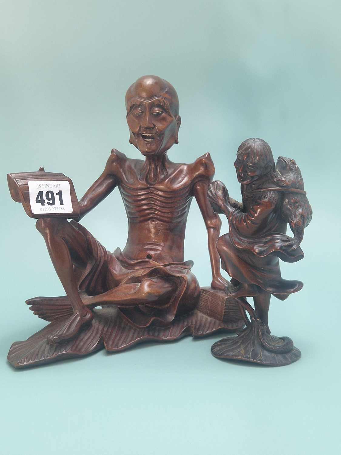 Lot 491 - A Chinese carved wood figure of Liu Hai...