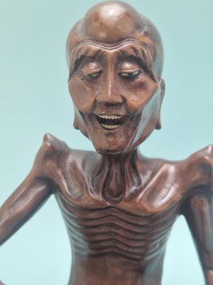 Lot 491 - A Chinese carved wood figure of Liu Hai...