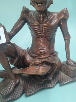 Lot 491 - A Chinese carved wood figure of Liu Hai...