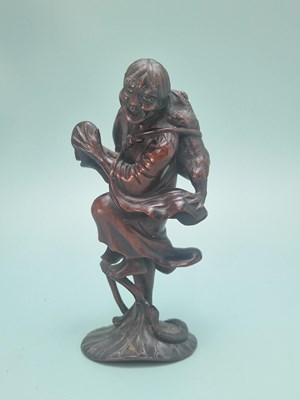 Lot 491 - A Chinese carved wood figure of Liu Hai...