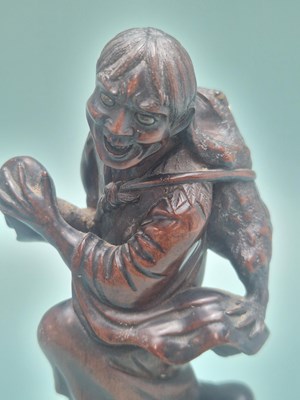 Lot 491 - A Chinese carved wood figure of Liu Hai...