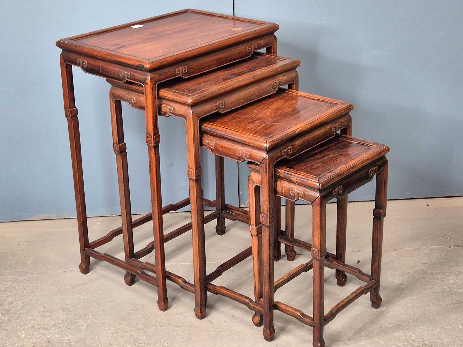 Lot 500 - A nest of four Chinese hardwood tables with...
