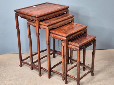 Lot 500 - A nest of four Chinese hardwood tables with...