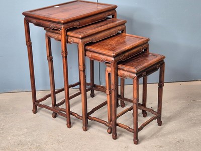 Lot 500 - A nest of four Chinese hardwood tables with...