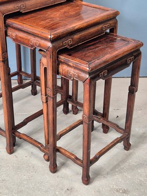Lot 500 - A nest of four Chinese hardwood tables with...