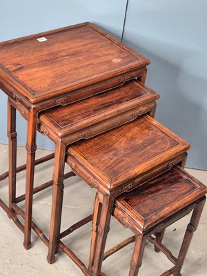 Lot 500 - A nest of four Chinese hardwood tables with...