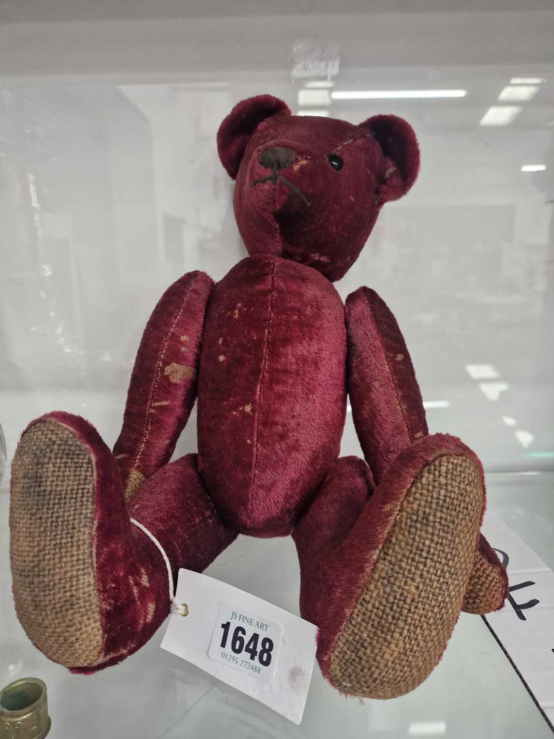 Lot 1648 - A purple plush teddy bear