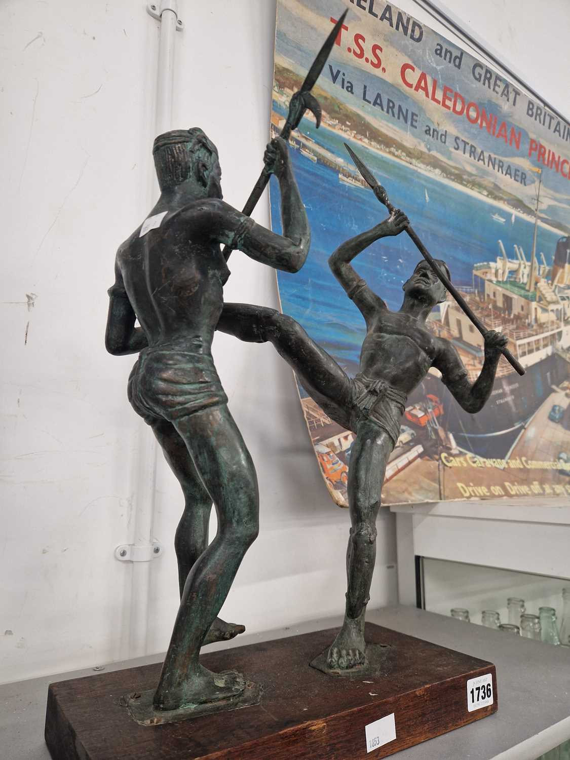 Lot 1736 - A bronze group of two tribesmen fighting with...