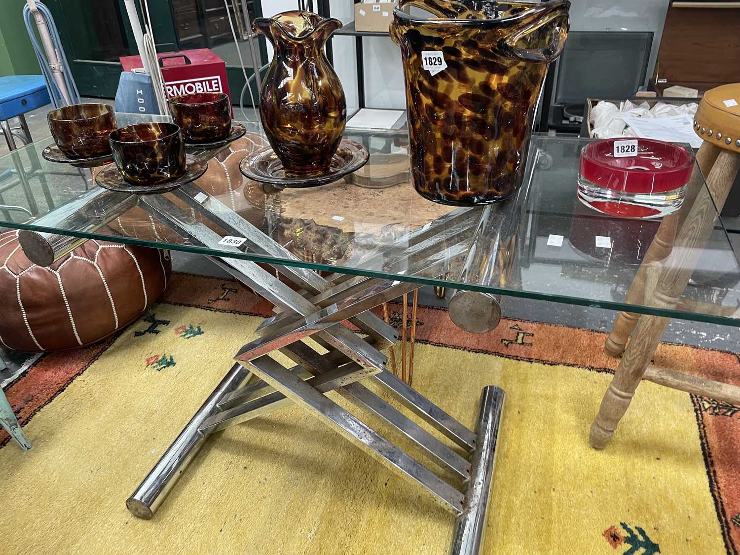 Lot 1830 - A glass topped coffee table on a chrome...