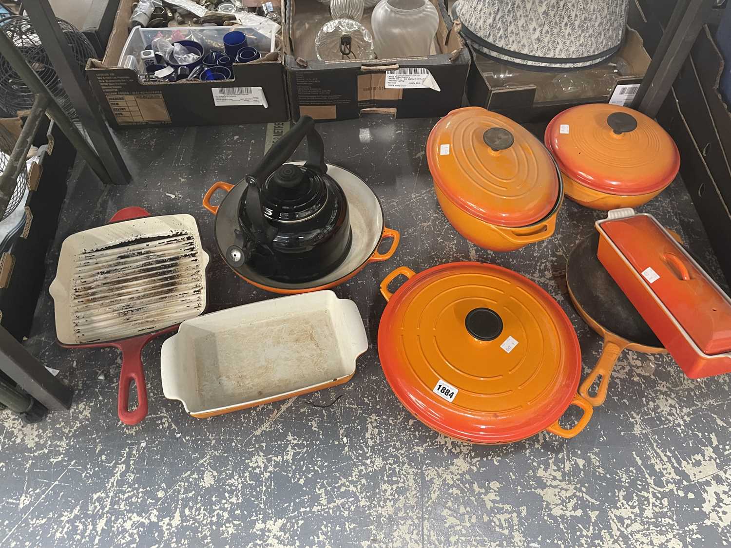 Lot 1884 - A collection of Le Creuset orange pots and pans