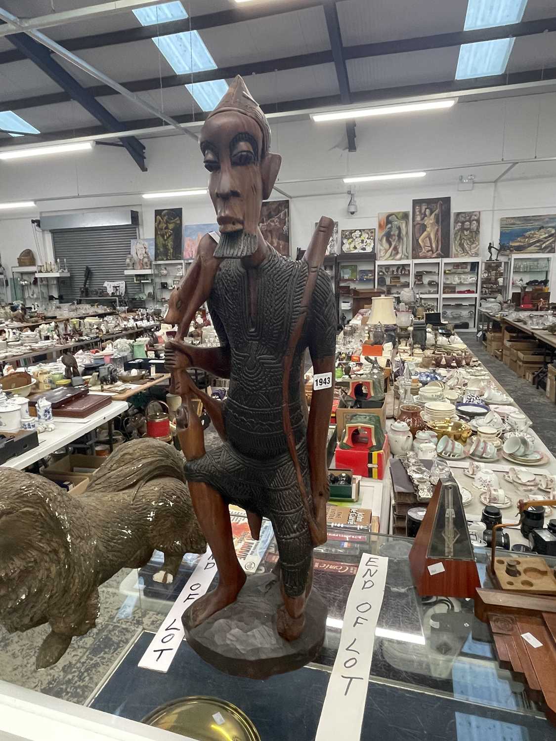 Lot 1943 - An African carved wood figure of a hunter