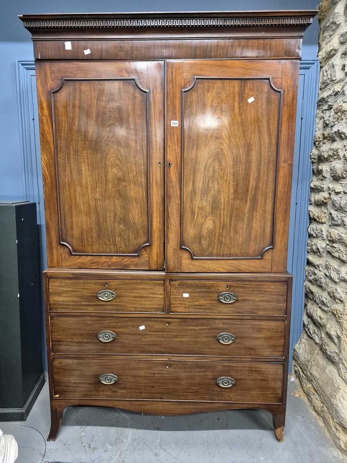 Lot 848 - A George III mahogany linen press, the key...
