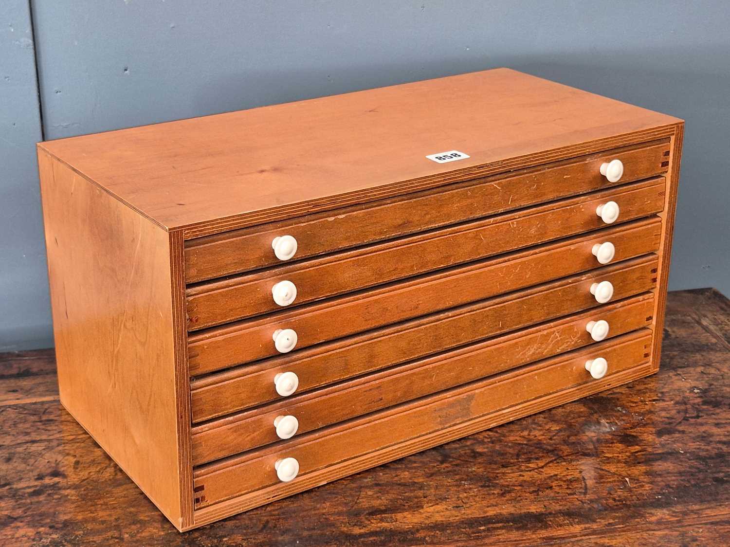 Lot 858 - A plywood coin collectors chest of six fitted...