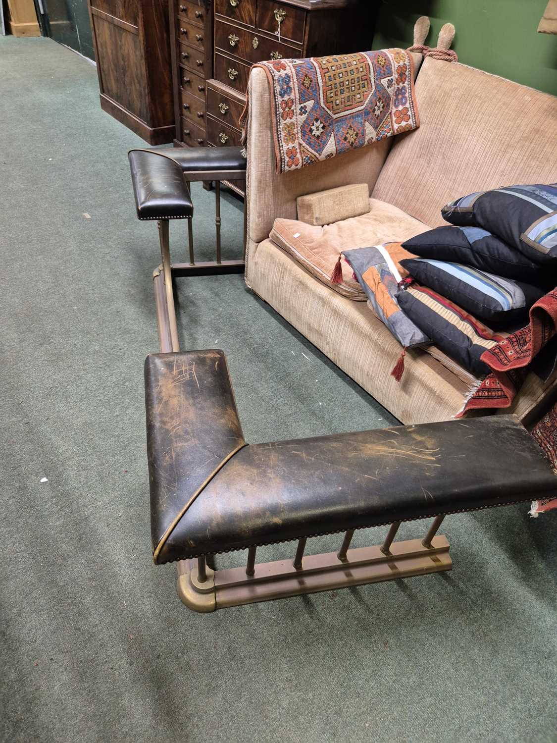 Lot 894 - A green leather seated brass club fender....