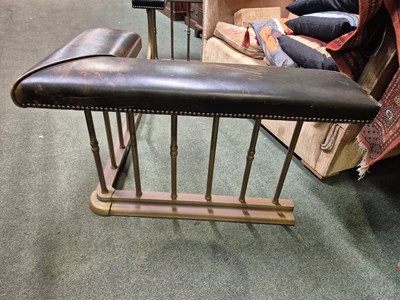 Lot 894 - A green leather seated brass club fender....