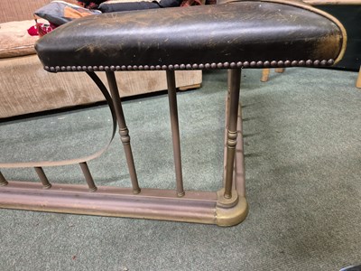 Lot 894 - A green leather seated brass club fender....