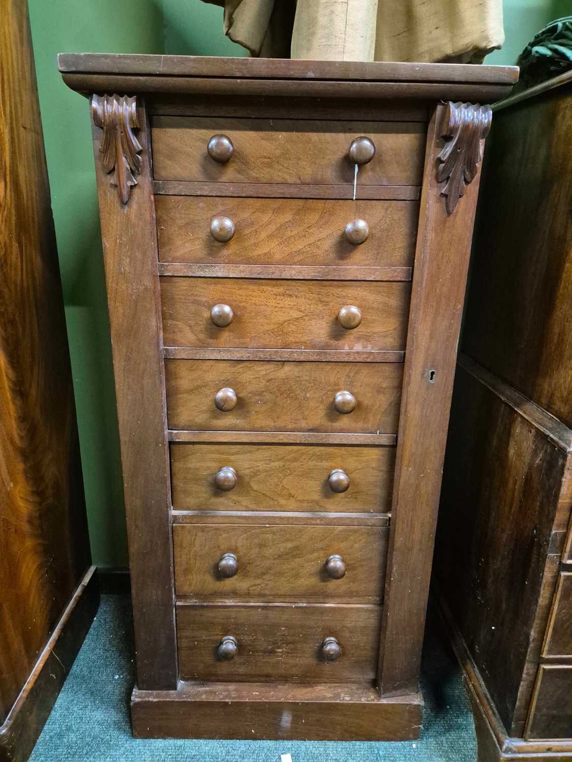Lot 898 - A mahogany wellington chest of seven drawers...