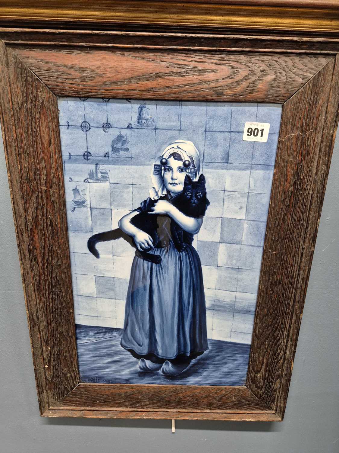Lot 901 - A framed Delft blue and white tile decorated...
