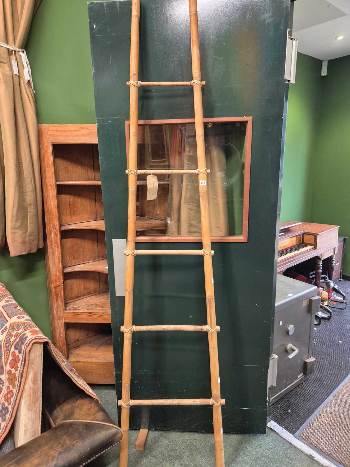 Lot 915 - A bamboo five rung ladder tapering towards the...