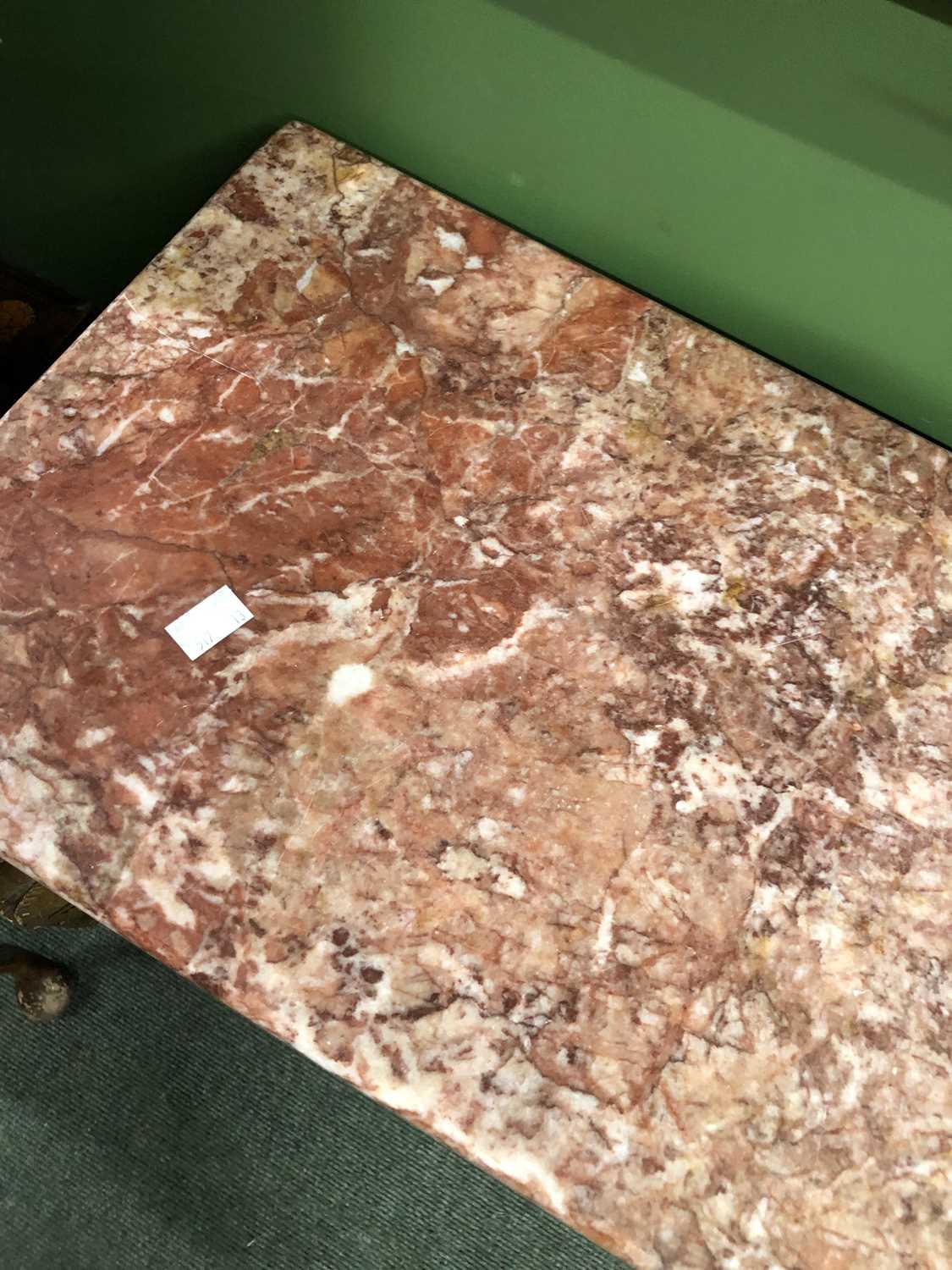 Lot 921 - A mottled pink marble topped console with a...