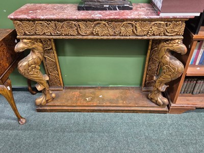 Lot 921 - A mottled pink marble topped console with a...