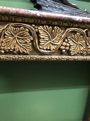 Lot 921 - A mottled pink marble topped console with a...