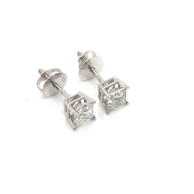 Lot 16 - A pair of princess-cut diamond stud earrings...