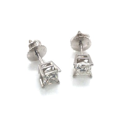 Lot 16 - A pair of princess-cut diamond stud earrings...