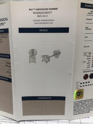 Lot 16 - A pair of princess-cut diamond stud earrings...