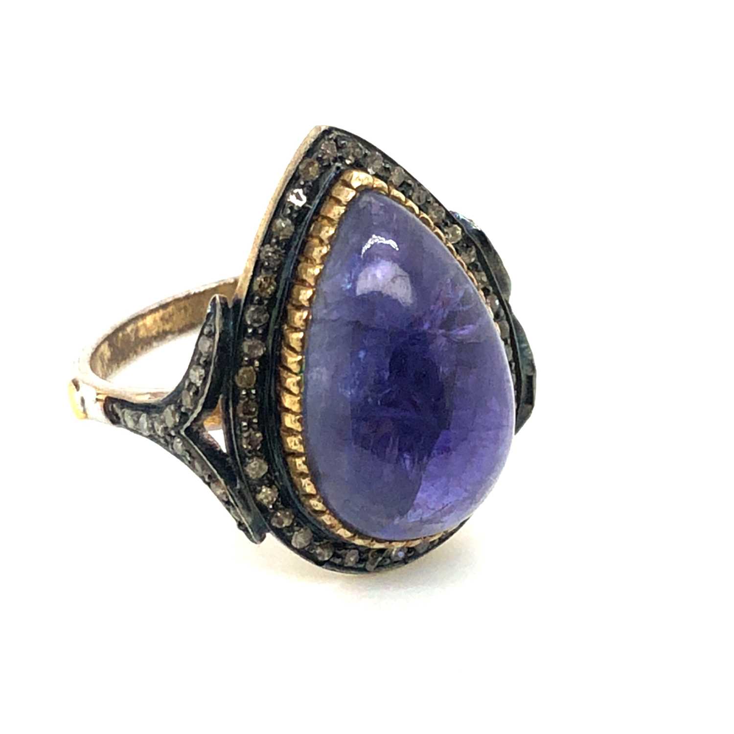 Lot 35 - A pear-shaped cabochon tanzanite and diamond...