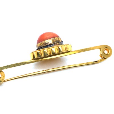 Lot 37 - An antique coral cabochon set bar brooch....