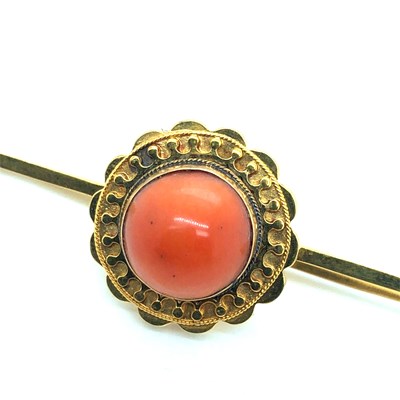 Lot 37 - An antique coral cabochon set bar brooch....