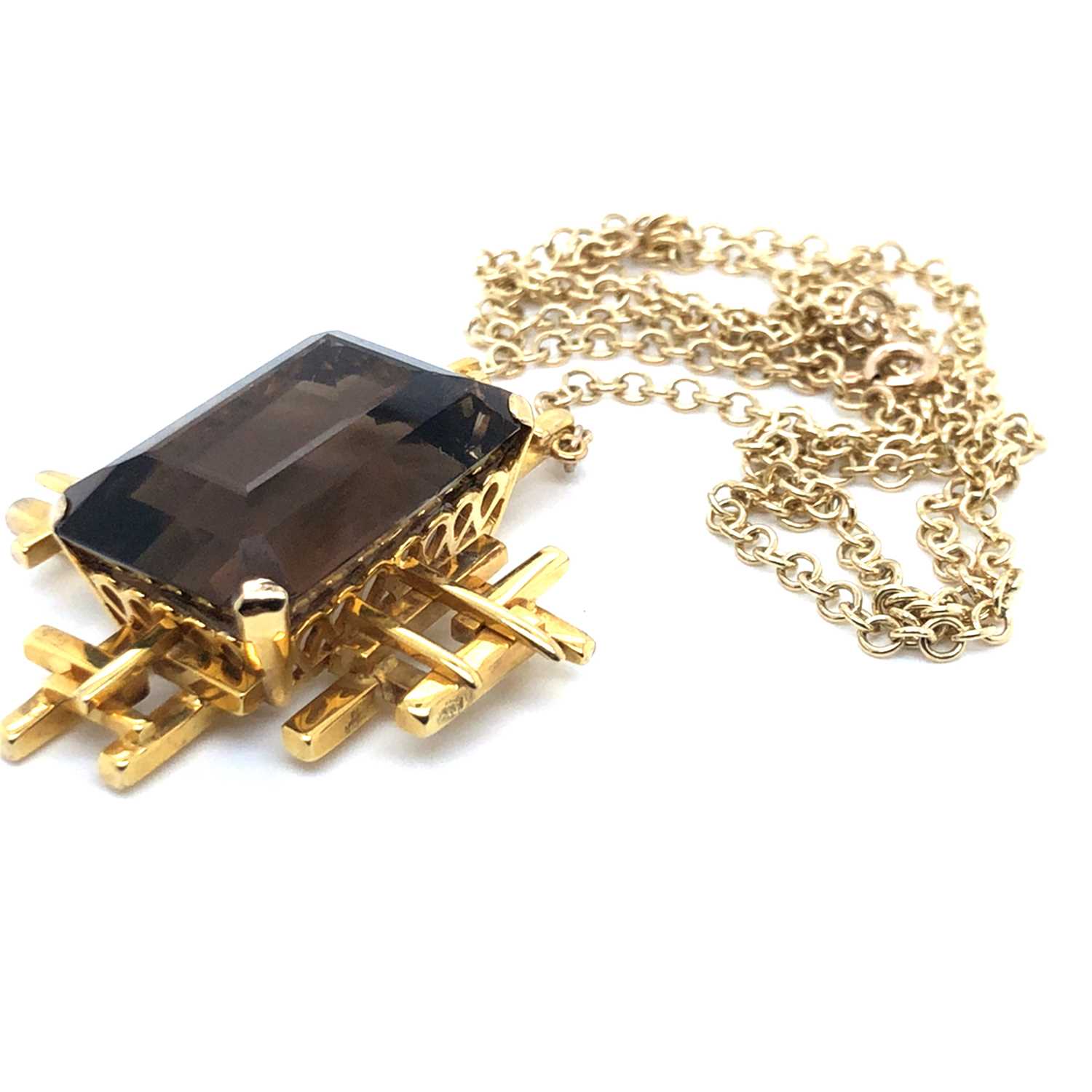 Lot 30 - A Brutalist style smokey quartz pendant...