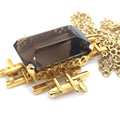 Lot 30 - A Brutalist style smokey quartz pendant...