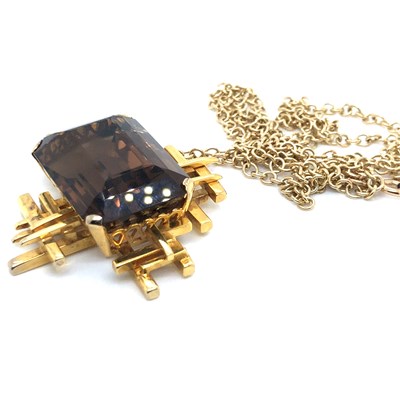 Lot 30 - A Brutalist style smokey quartz pendant...