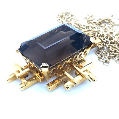 Lot 30 - A Brutalist style smokey quartz pendant...