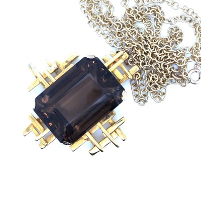 Lot 30 - A Brutalist style smokey quartz pendant...