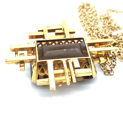 Lot 30 - A Brutalist style smokey quartz pendant...