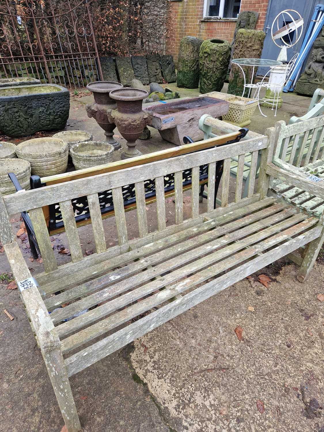 Lot 732 - A teak garden bench. H 83 W 153 D 53 cm